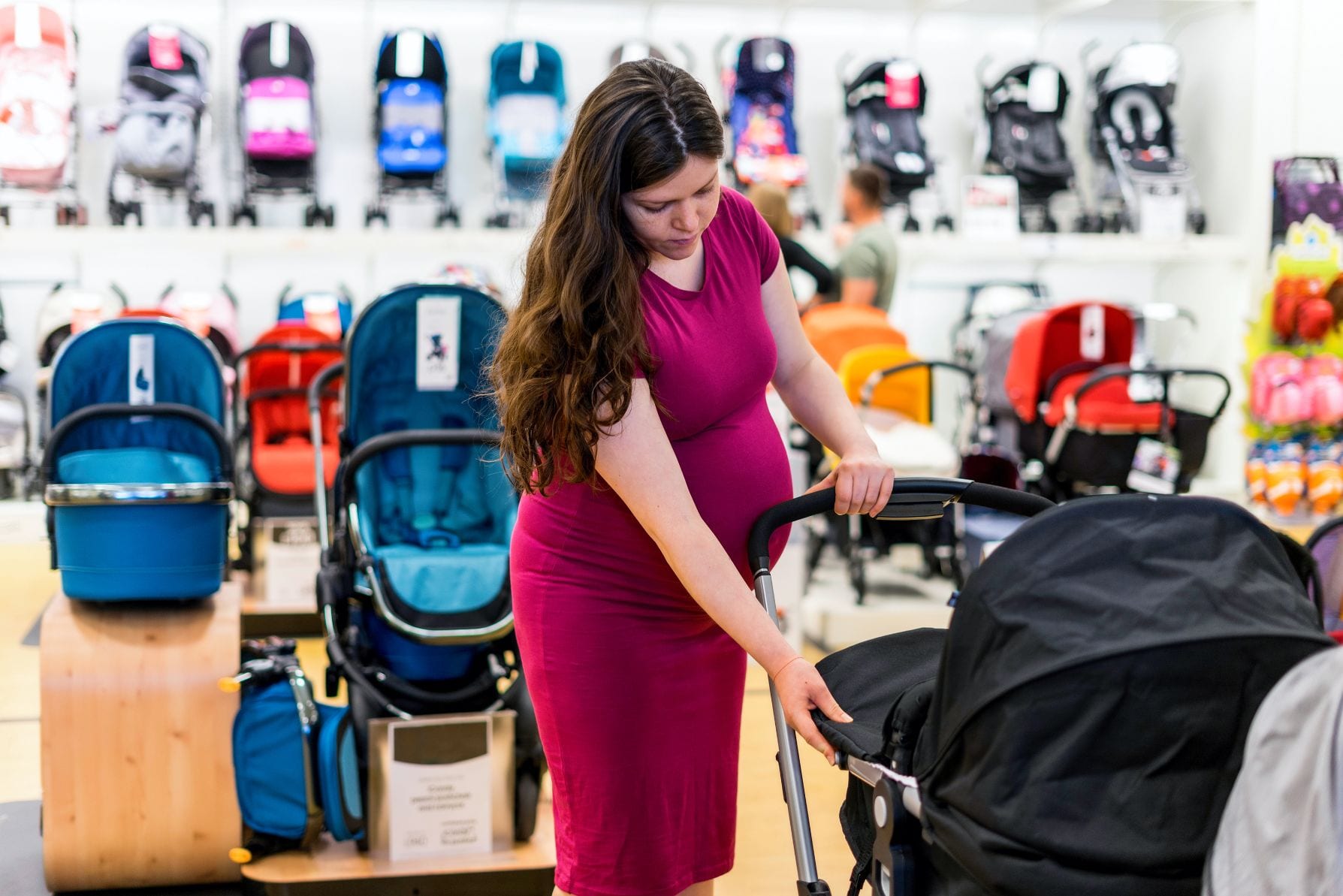 pregnant woman buying pushchairs